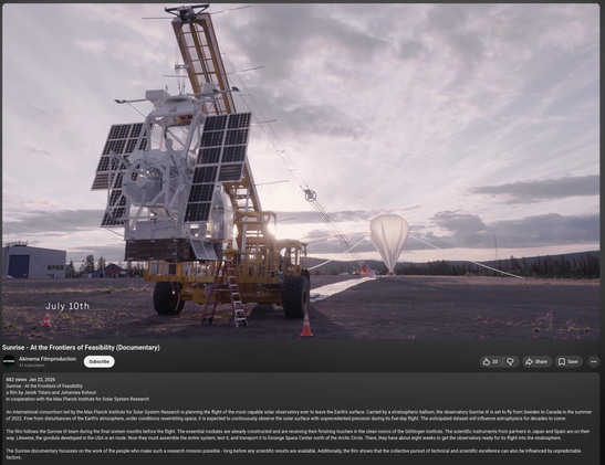 Screenshot of a frame of the Youtube movie. It shows the Sunrise III telescope hanging from a specialised carrier vehicle on a vast flat range. A large stratospheric balloon is seen slowly inflating in the background.