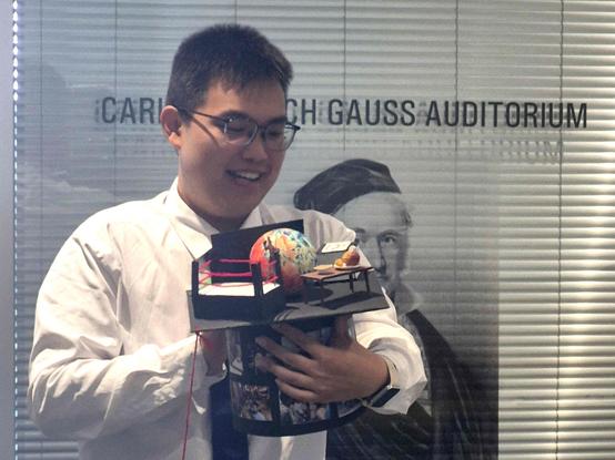 Yifeng Fu admiring his doctoral hat